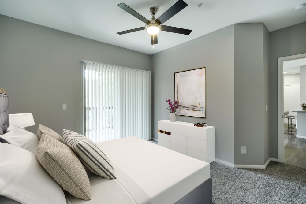 Large bedroom with a ceiling fan at The Grove at Orenco Station in Hillsboro, Oregon