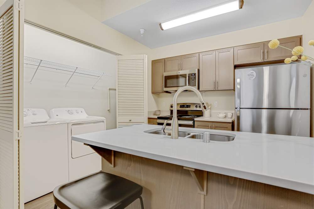 Kitchen with side by side washer/dryer at Haven Hills in Vancouver, Washington