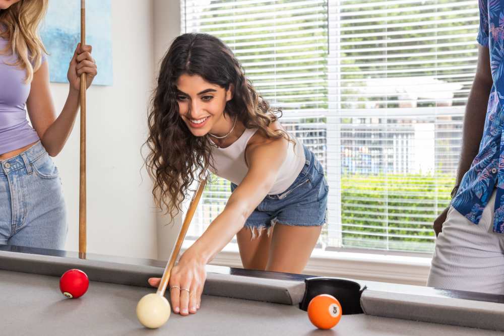 People playing pool at Breckinridge Point Apartments in Richardson, TX