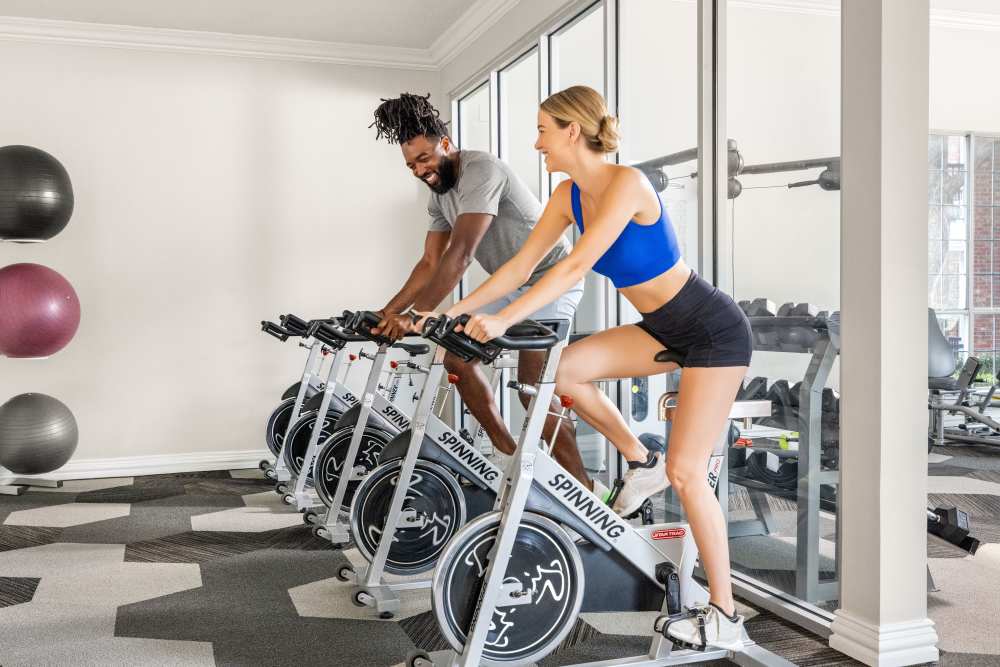 People enjoying fitness center at Breckinridge Point Apartments in Richardson, TX
