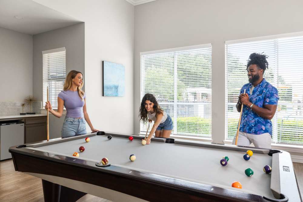 People playing billiards at Breckinridge Point Apartments in Richardson, TX
