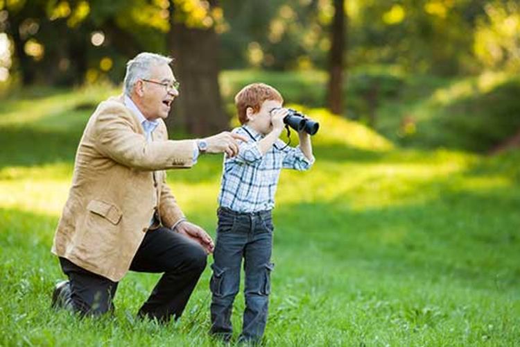 Resident showing his grandson some birdwatching techniques at Arcadia Senior Living Pace in Pace, Florida