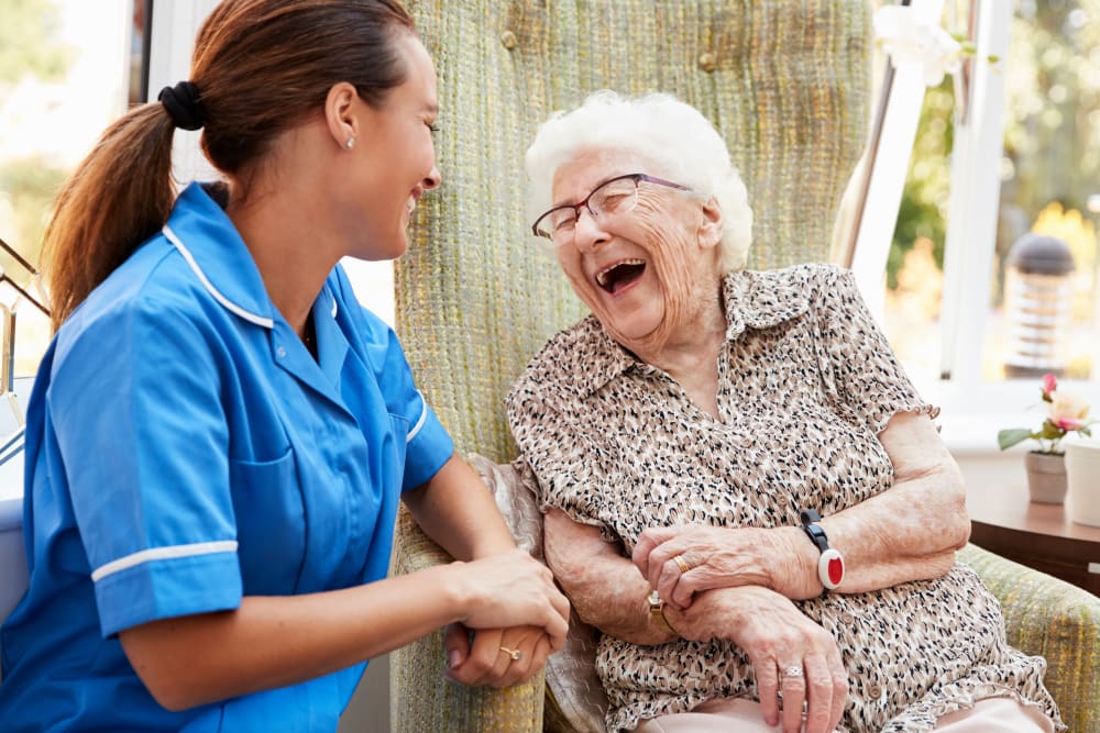 Resident and a nurse sitting outside talking at Randall Residence of Centerville in Centerville, Ohio