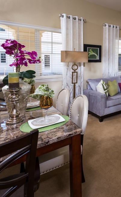 Dining table and cozy living room at Estancia Del Sol in Corona, California
