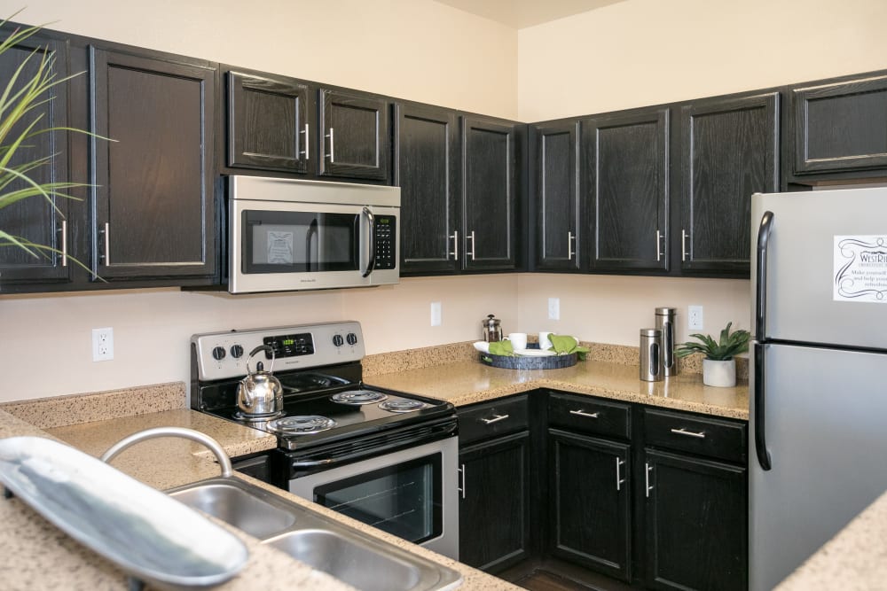 A kitchen with plenty of cabinet space at Westridge Apartments in Aurora, Colorado