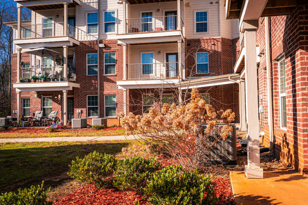 Beautiful view of apartments from exterior with walkways at Redland Creek in Lawrenceville, Georgia