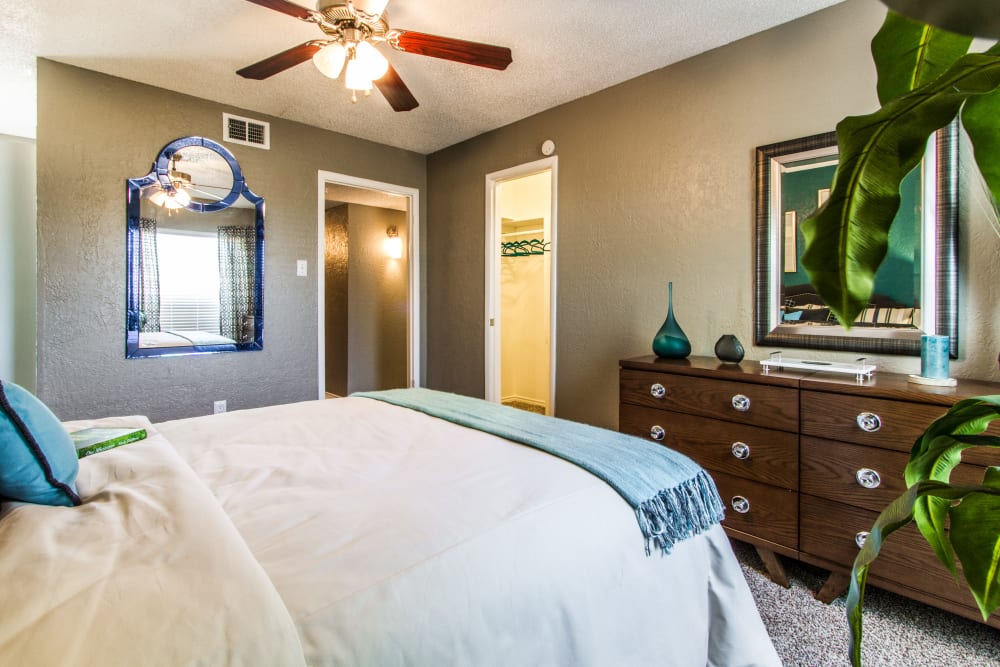 Spacious model bedroom with ceiling fan at Sundance Apartments in College Station, Texas