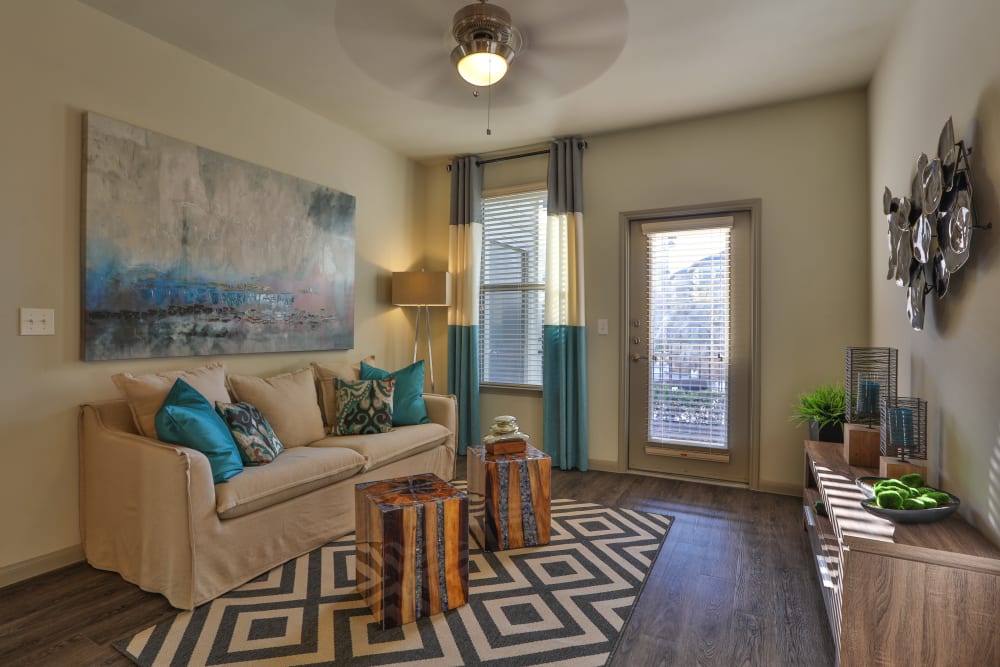 Model living room at Olympus at Waterside Estates in Richmond, Texas