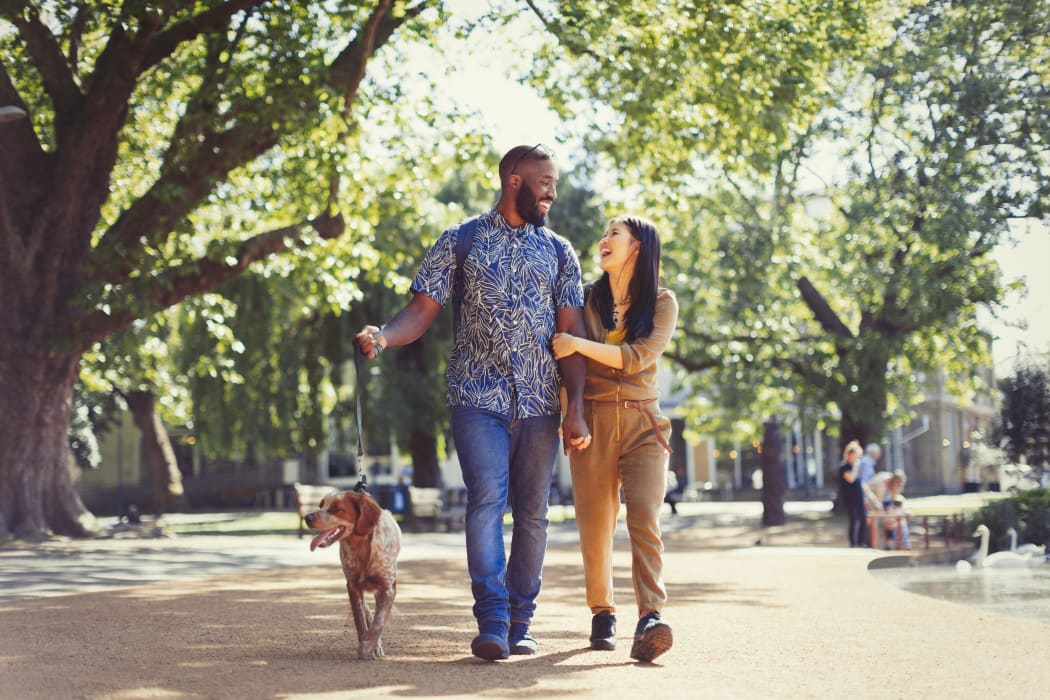 Couple walking their dog near Arbors of Pleasant Valley in Little Rock, Arkansas