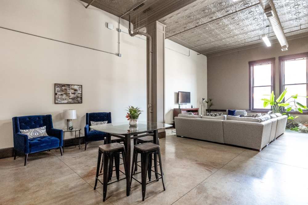 Blue chairs and a glass table at Rumely Lofts in Des Moines, Iowa