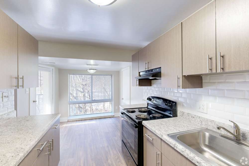 Kitchen with range and wooden cabinets at Knights Bridge II in Burtonsville Maryland