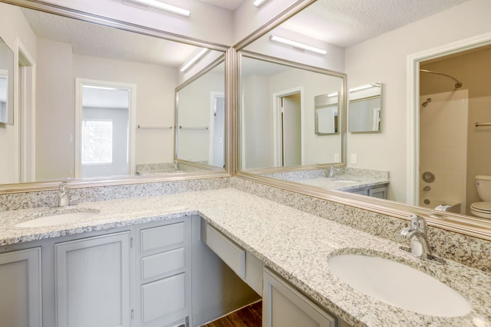 Model bathroom with two sinks at Turtle Creek Vista Apartments in San Antonio, Texas