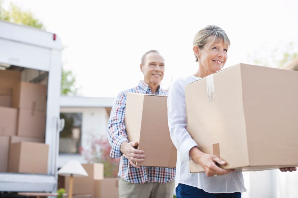 A couple unloading boxes from a truck near East Vancouver Self Storage in Vancouver, Washington