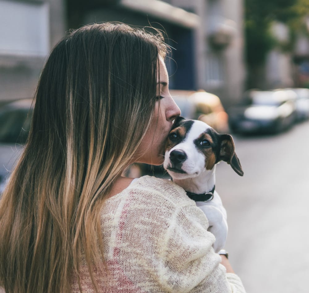 Resident kissing her dog at Vue Issaquah in Issaquah, Washington