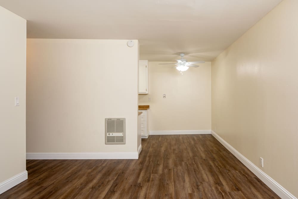 Spacious floor plan with wood-style flooring at Bayfair Apartment Homes in San Lorenzo, California