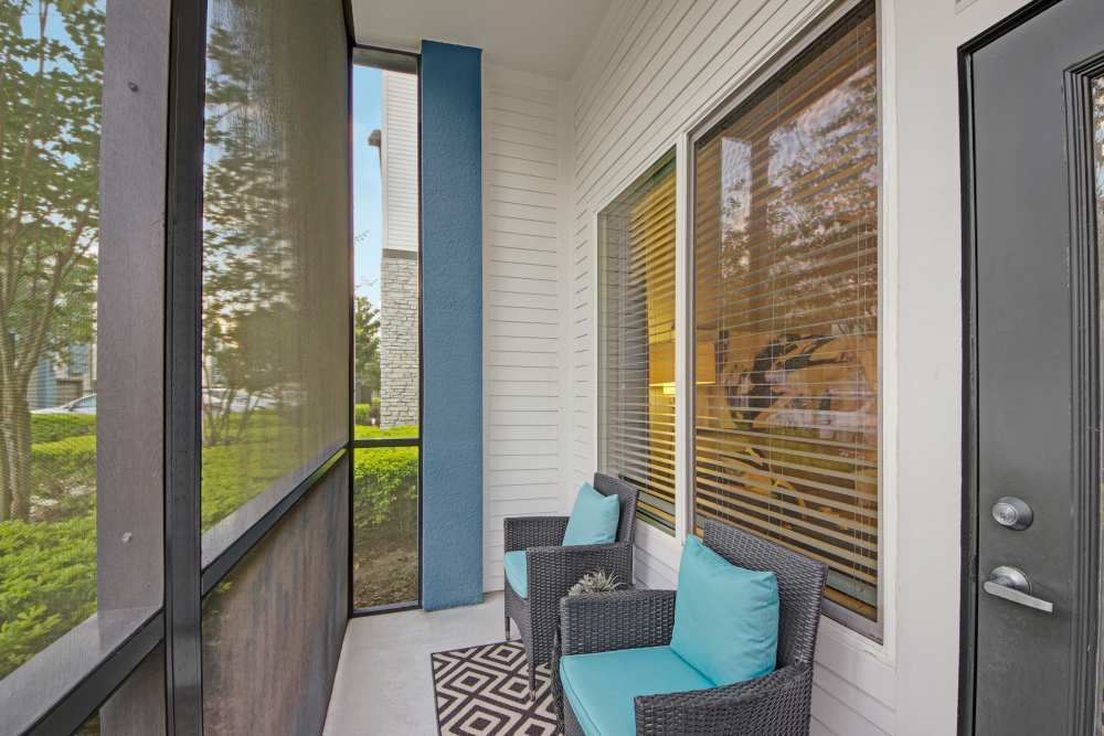 Spacious balcony with chairs and community few at The Courtney at Lake Shadow in Orlando, Florida