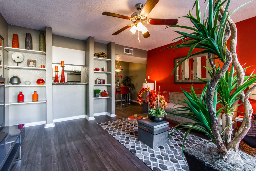 Modern living room with hardwood style flooring at Sausalito Apartments in College Station, Texas