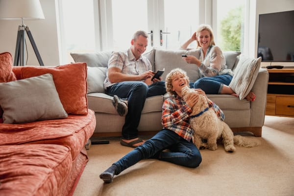 Happy family in their living room at Avilla Centerra Crossings in Goodyear, Arizona