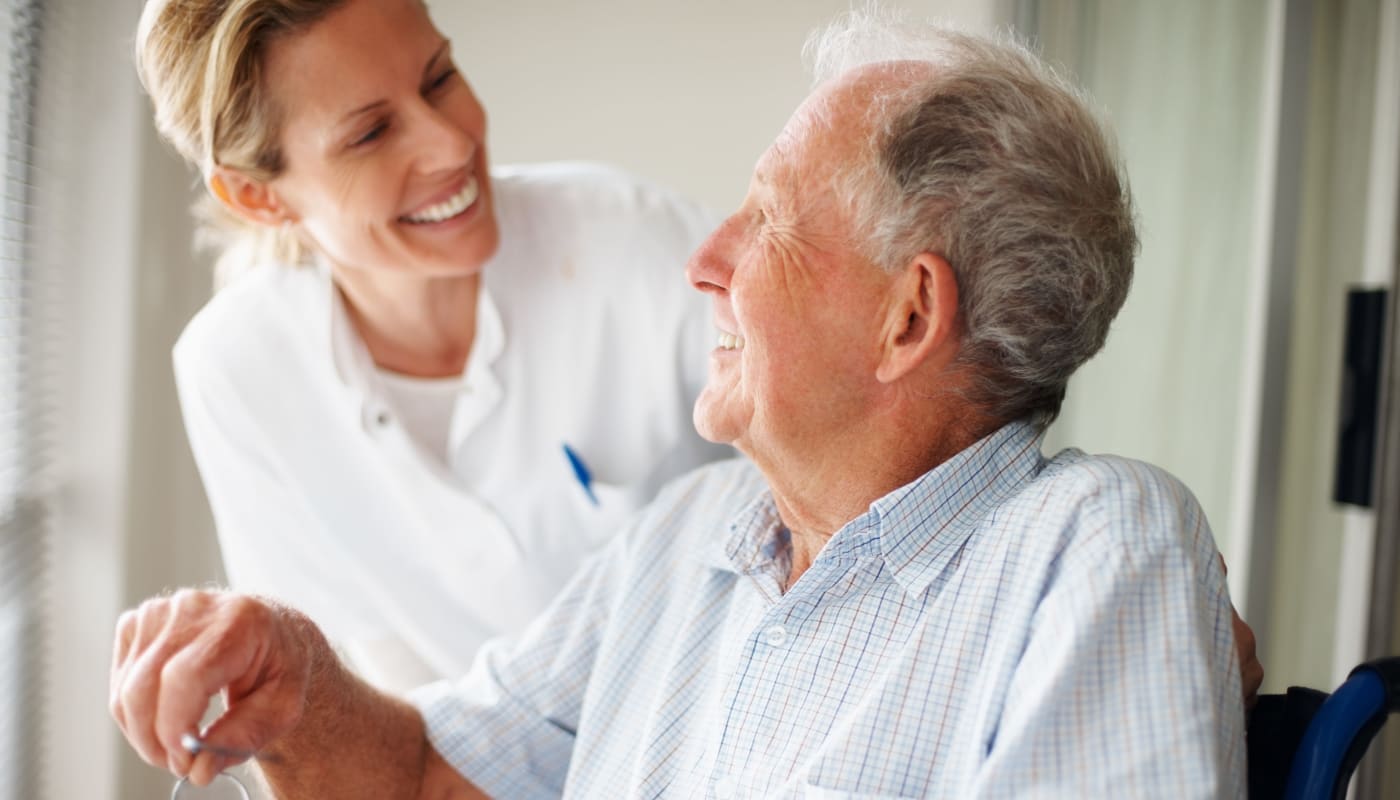 Staff member helping a resident at Willow Creek Senior Living in Elizabethtown, Kentucky.