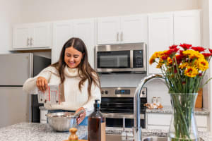 A resident prepares a meal in her kitchen at The Waters at Settlers Trace, Lafayette, Louisiana