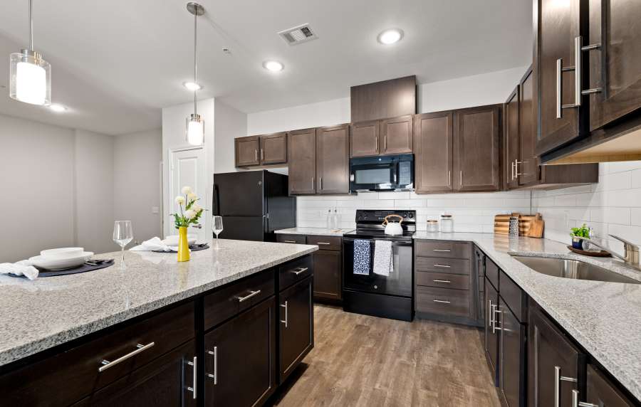 Modern kitchen with granite countertops at Walnut Springs in Seguin, Texas