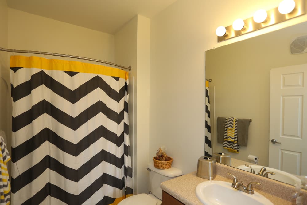 Modern washroom with large mirror at Adams Crossing Apartment Homes in Waldorf, Maryland
