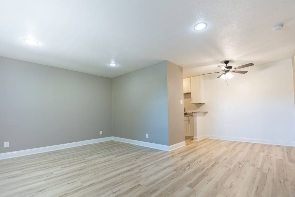 Living area and open model kitchen in the apartment at Lakeshore Villa Apartments in Rowlett, Texas