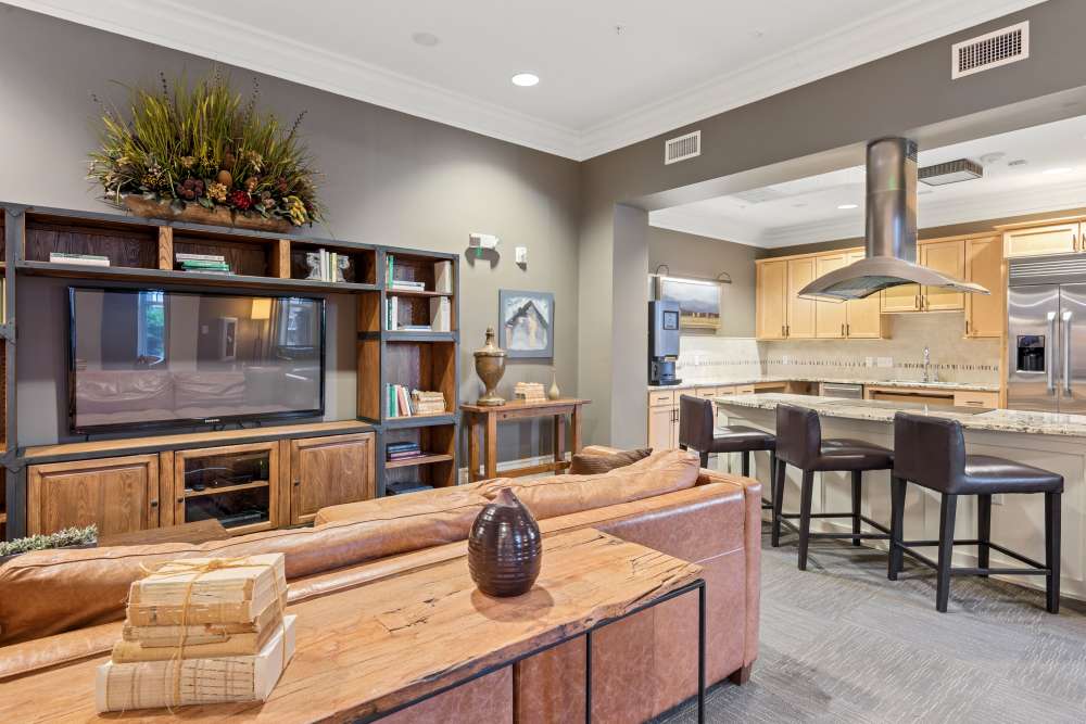 Community clubhouse kitchen with breakfast bar at Fountains at Mooresville Town Square in Mooresville, North Carolina