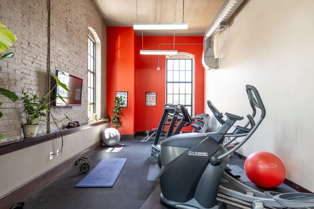 Red accent wall with large windows at Rumely Lofts in Des Moines, Iowa