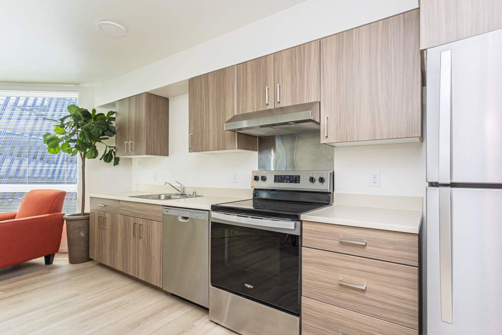 Apartment kitchen with energy-efficient appliances at Connection Angle Lake in SeaTac,Washington
