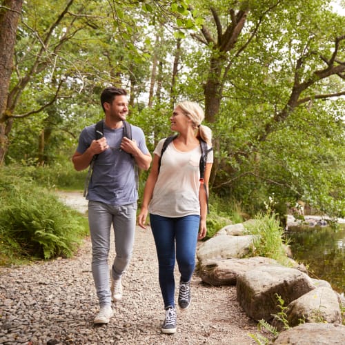 Couple walking through a local park near Jewel Lake Villa in Anchorage, Alaska