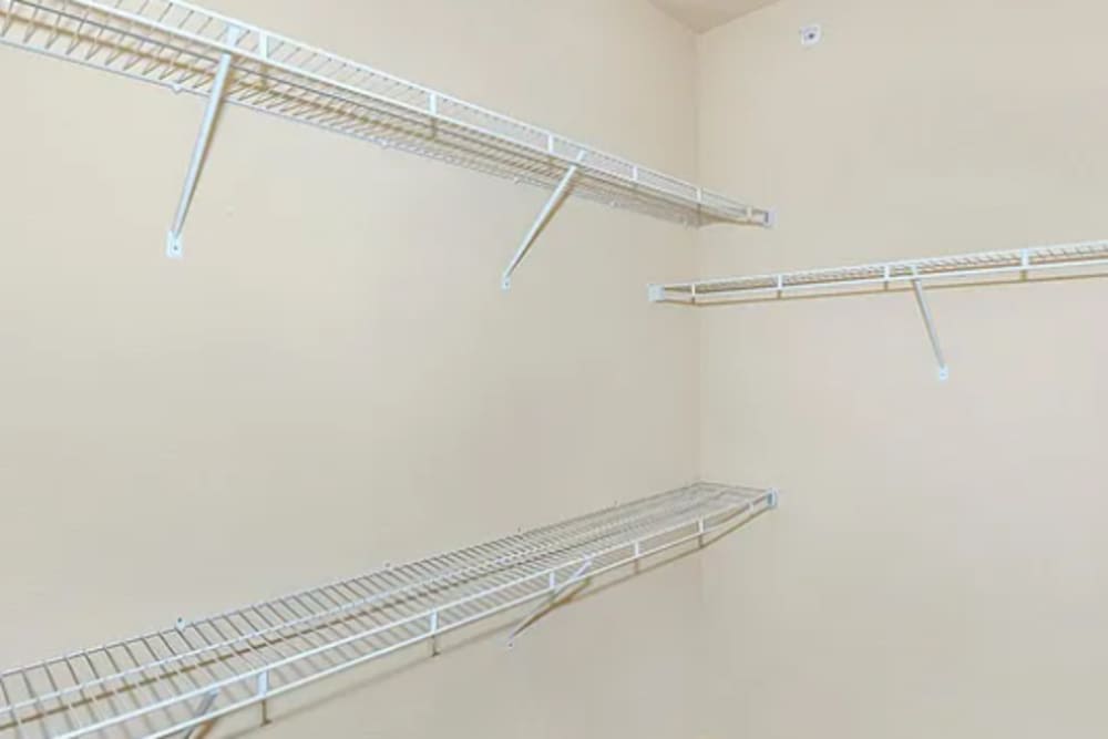 Modern walk-in closet with wire shelving at Villas On Independence in Port Lavaca, Texas