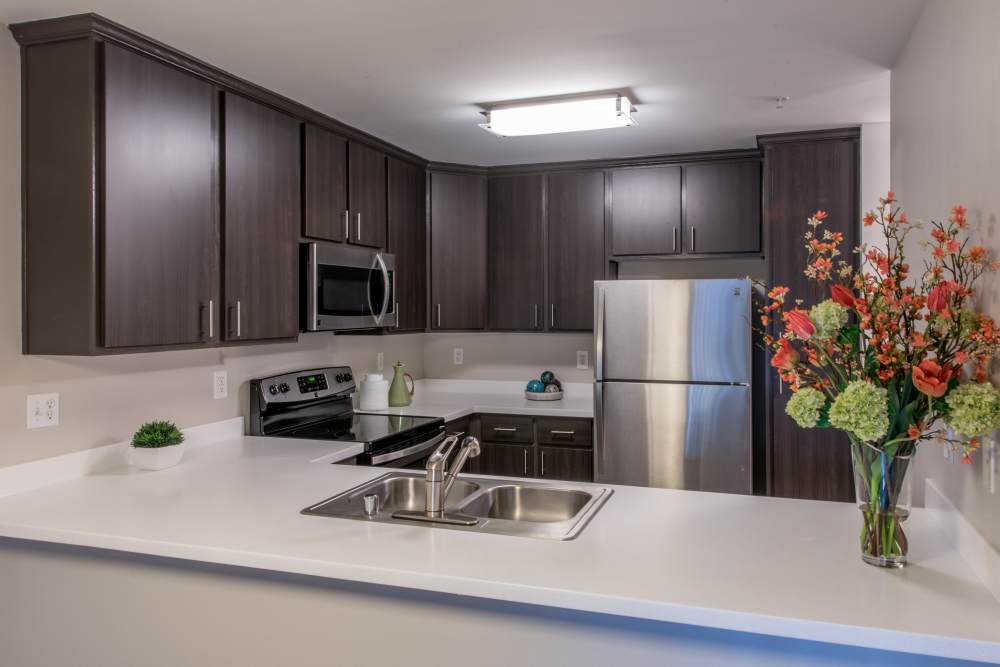 Spacious kitchen with wood cabinets at Brookside Village in Auburn, Washington