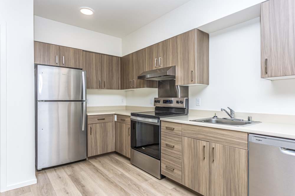 Kitchen with cabinetry and appliances at Connection Angle Lake in SeaTac, Washington