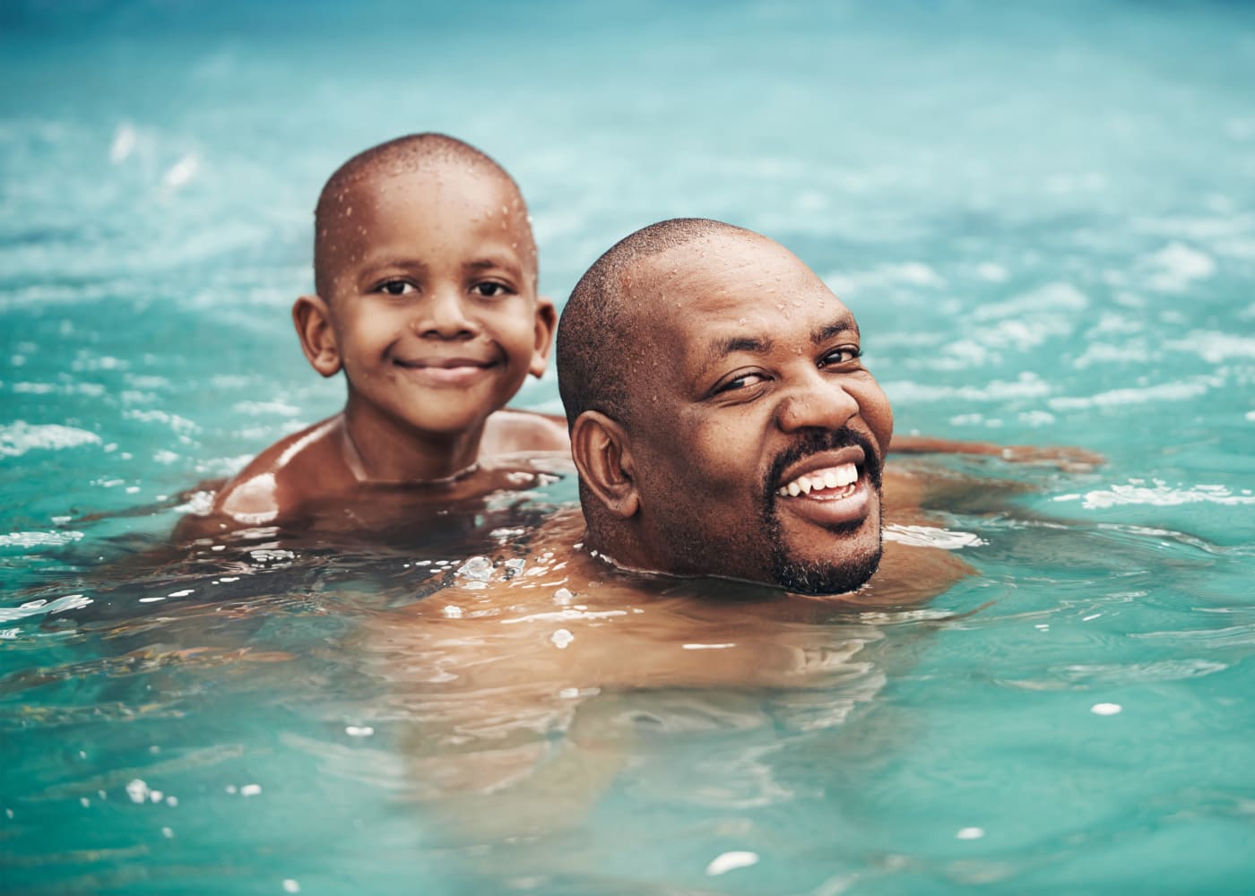 Father and son enjoying the swimming pool at The Willows in Gaithersburg, Maryland