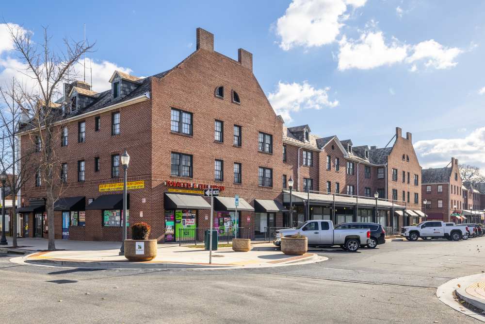 Community exterior building with road side parking at Dundalk Village in Dundalk, Maryland