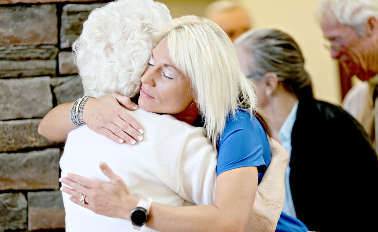 Resident and caretaker embracing in a hug at Providence Assisted Living in Searcy, Arkansas.