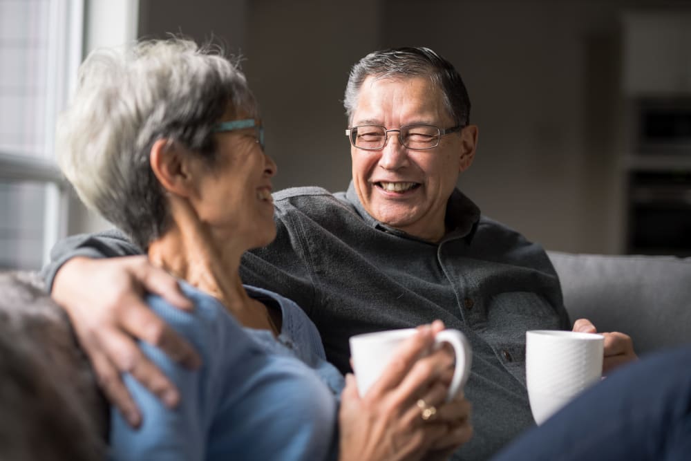 A happy couple with coffee cups at Brightwater Senior Living of Linden Ridge in Winnipeg, Manitoba