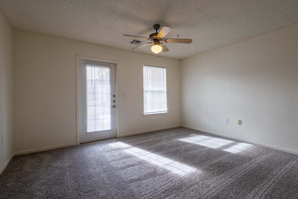 Charming bedroom with abundant natural light and cozy carpet at Adobe Ranch in Borger, Texas.