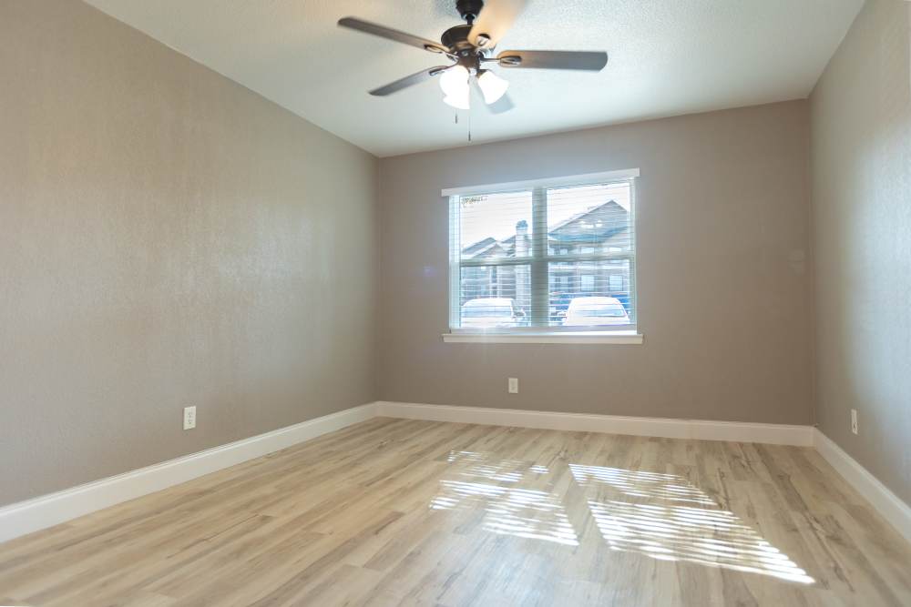 Unfurnished bedroom with wooden flooring at Lakeshore Villa Apartments in Rowlett, Texas