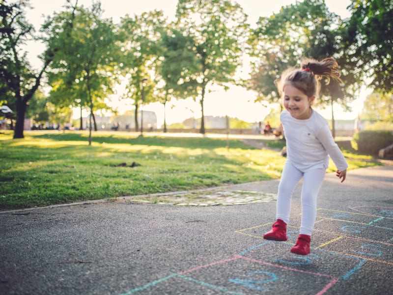 Child playing hopscotch at Oakwood Apartments in West Carrollton, Ohio