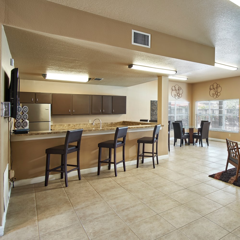 A community kitchen with a bar at Calais Park Apartments in St Petersburg, Florida