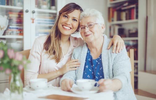 Resident and caretaker enjoying a cup of tea at Weatherly Court in Medford, Oregon