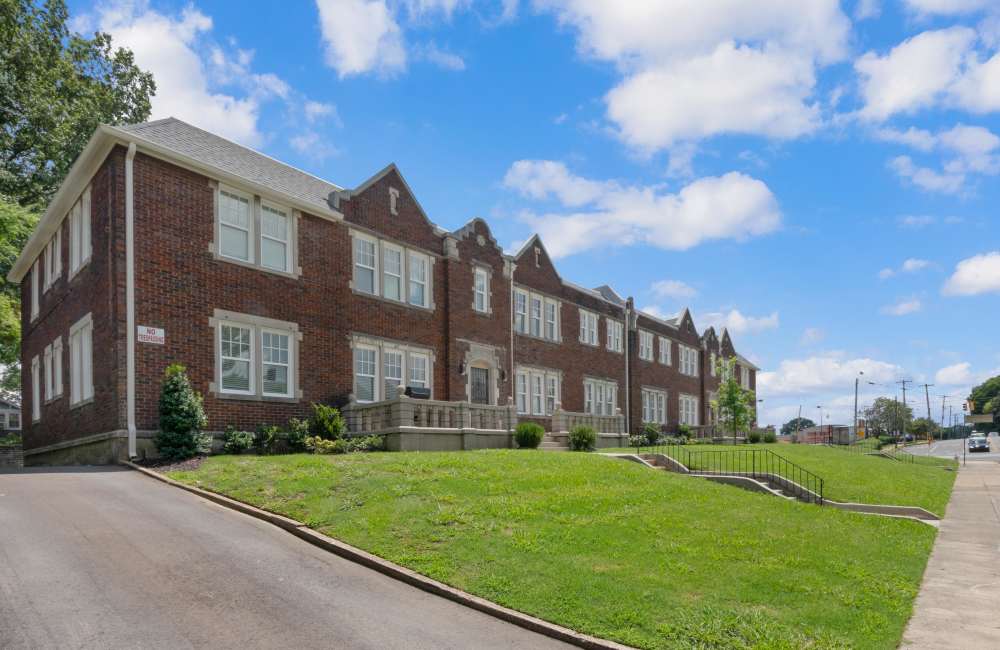 Exterior of apartment with green lawns in the front yard at The Avalon in Memphis, Tennessee