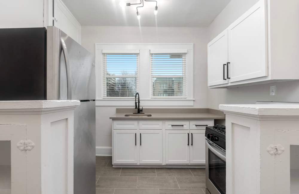 Fully equipped kitchen with white cabinets at The Alma in Memphis, Tennessee