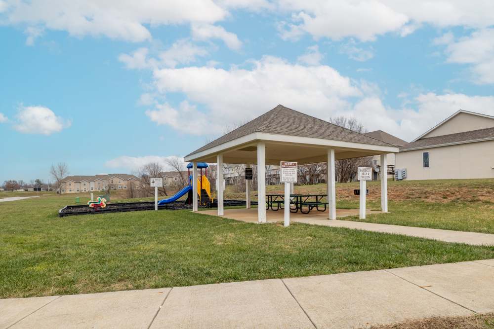 An apartment with a playground at Ridgeway Villas At The Legends in Raymore,Missouri