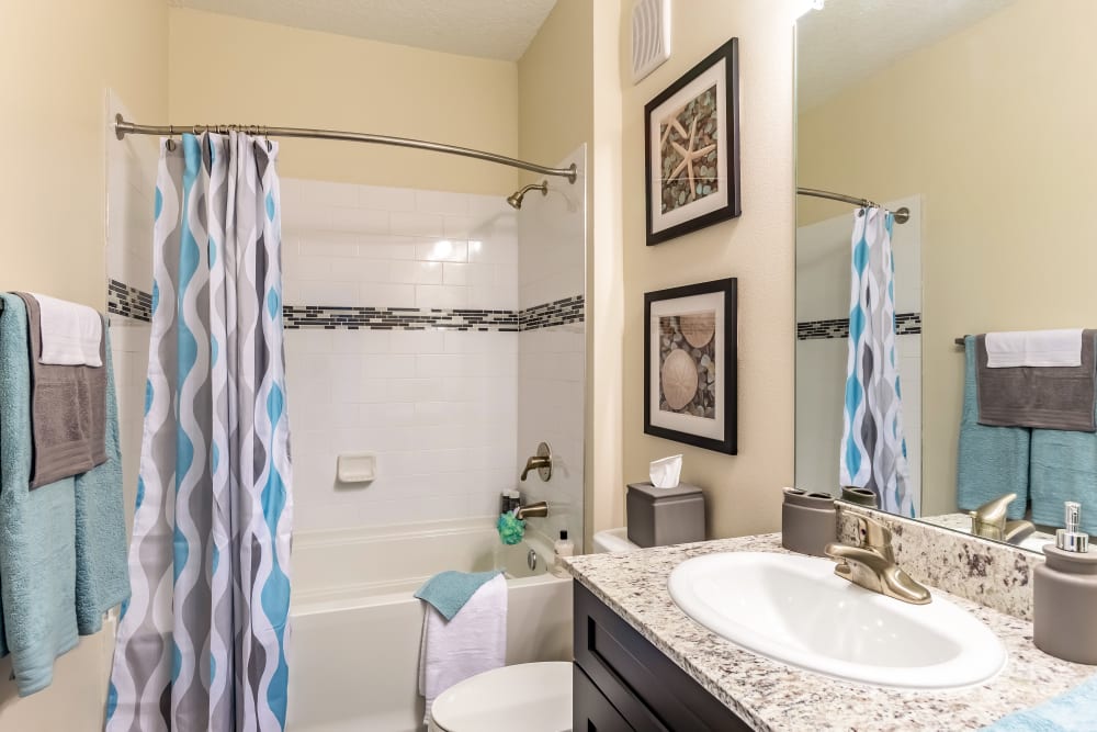 Bathroom with tiled shower/tub and oversized vanity at The Loop at 2800 in Sarasota, Florida