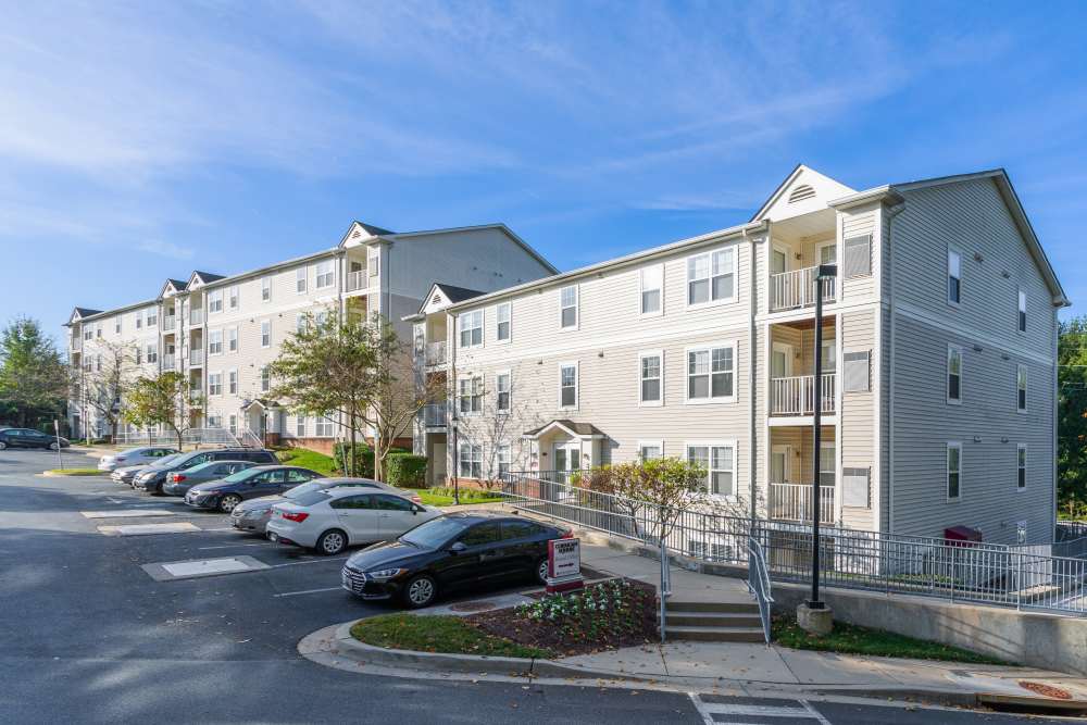Community exterior with parking at Corrigan Square Apartments in Gaithersburg, Maryland