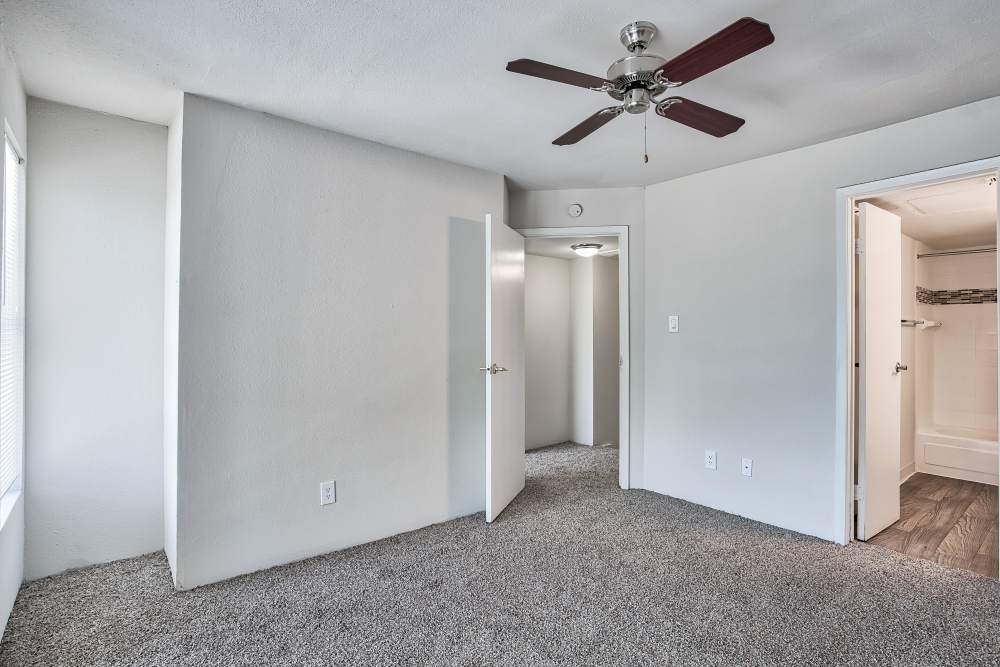 Bedroom with walk-in closets at Branch Creek Apartments in Carrollton, Texas