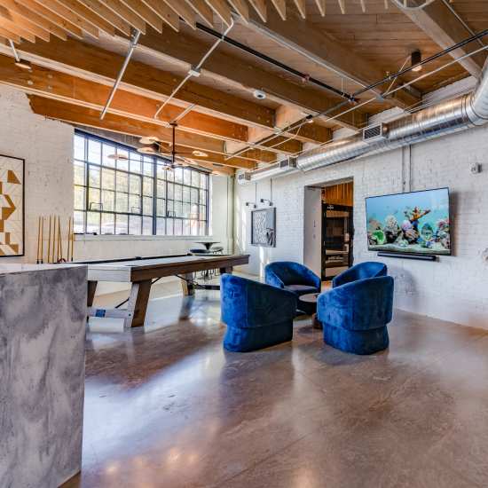 Community lounge with pool table at Box Board Lofts in Grand Rapids, Michigan